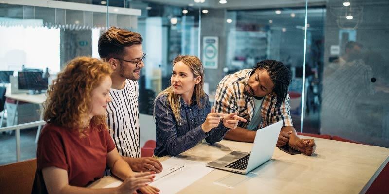 Employees discussing the AI tools available to them at work