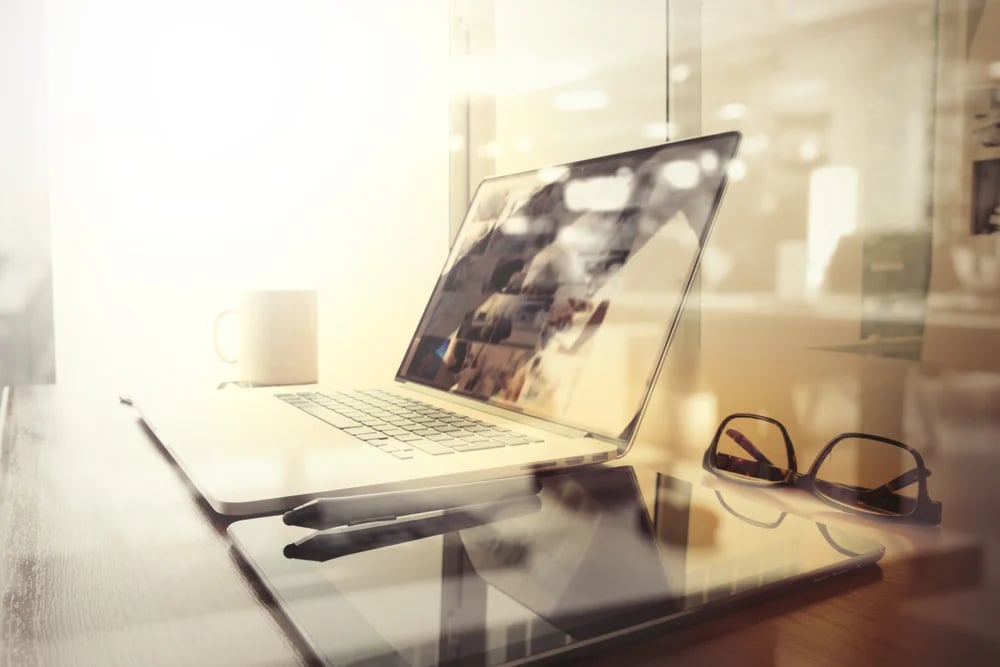 Office workplace with laptop and smart phone on wood table and london city blurred background-1