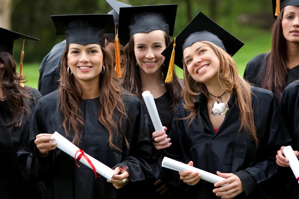 group of graduation students looking happy outdoors-1